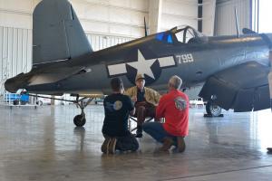corsair private event_Purdy speaking with two men by plane