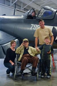 corsair private event_family posing with Purdy in front of plane