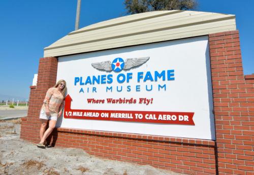 Planes of Fame - August 6, 2016 - michele posing by sign